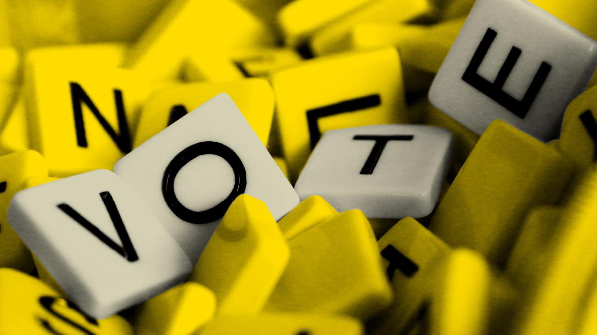 scrabble tiles spelling the word vote